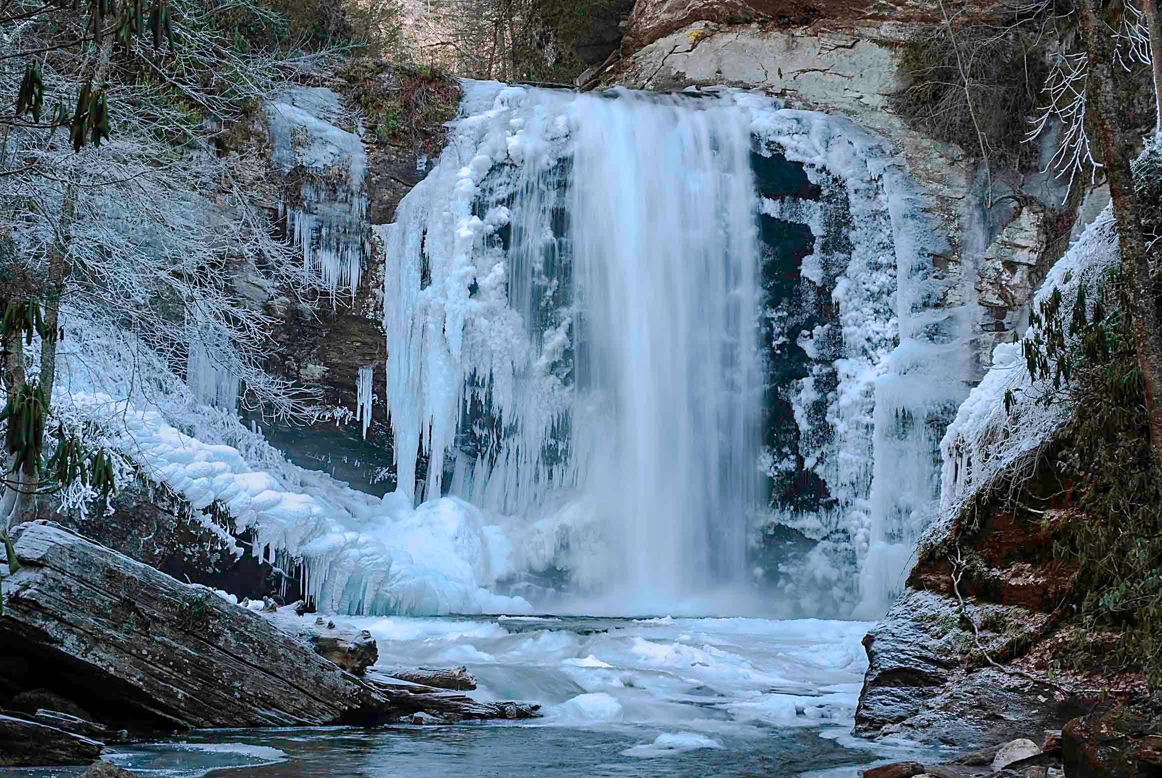 Looking Glass Falls nearly frozen solid with massive ice formations framing the cascade